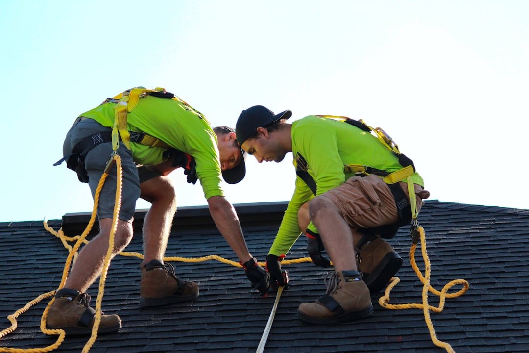 a-couple-of-men-working-on-a-roof-umjz4m-icow